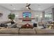 Inviting living room with a stone fireplace, modern furnishings, and a ceiling fan at 3018 Fall Solstice Ct, Las Vegas, NV 89138