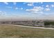 This view showcases the neighborhood landscape, with a skyline of buildings, mountains, and clouds at 3018 Fall Solstice Ct, Las Vegas, NV 89138