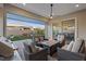 Inviting covered patio featuring comfortable seating around a modern fire pit table and an outdoor grill at 3018 Fall Solstice Ct, Las Vegas, NV 89138