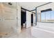 Bright bathroom with walk-in shower, soaking tub, vanity, and city views at 322 Karen Ave # 2501, Las Vegas, NV 89109