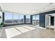 Bright living room featuring tile flooring, floor-to-ceiling windows, and a sliding door to balcony with city views at 322 Karen Ave # 2501, Las Vegas, NV 89109