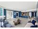 Open-concept living room with a modern kitchen, balcony access, and stylish contemporary furnishings at 322 Karen Ave # 2501, Las Vegas, NV 89109