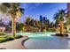 Beautiful community pool area with swaying palm trees and comfortable seating at 322 Karen Ave # 2501, Las Vegas, NV 89109