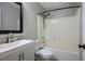 Bathroom showcasing a white vanity, framed mirror, and tiled shower-tub combo at 3334 Flying Colt Ct, North Las Vegas, NV 89032