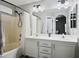 Bathroom featuring double sinks, a large mirror, and a shower-tub combination at 3334 Flying Colt Ct, North Las Vegas, NV 89032