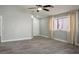 Spacious bedroom with wood-look tile flooring and a window dressed with soft curtains at 3334 Flying Colt Ct, North Las Vegas, NV 89032