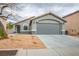 Charming single story home with a two car garage, desert landscaping, and neutral paint at 3334 Flying Colt Ct, North Las Vegas, NV 89032