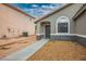 Inviting home exterior showcasing desert landscaping, covered entry, and textured stone accents at 3334 Flying Colt Ct, North Las Vegas, NV 89032