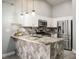 Stylish kitchen featuring stone backsplash, stainless steel appliances, and a breakfast bar at 3334 Flying Colt Ct, North Las Vegas, NV 89032