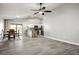 Open concept living space featuring tile flooring, a ceiling fan, and combined kitchen and dining areas at 3334 Flying Colt Ct, North Las Vegas, NV 89032