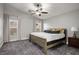 Cozy main bedroom featuring a ceiling fan, carpet, and soft, neutral-toned curtains at 3334 Flying Colt Ct, North Las Vegas, NV 89032