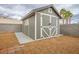 This shed has an attractive facade with double doors and a small window at 3334 Flying Colt Ct, North Las Vegas, NV 89032