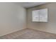 This bedroom features neutral carpet, bright natural light, and a ceiling fan at 3640 Chateau Meadow St, Las Vegas, NV 89129