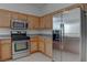 Well-equipped kitchen featuring stainless steel appliances and light wood cabinets at 3640 Chateau Meadow St, Las Vegas, NV 89129