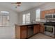 Well-equipped kitchen featuring stainless steel appliances, bar seating and tile floors at 3640 Chateau Meadow St, Las Vegas, NV 89129