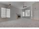 Bright living room featuring neutral carpet, fireplace, and ample natural light at 3640 Chateau Meadow St, Las Vegas, NV 89129