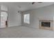 Spacious living room featuring neutral carpet and a cozy fireplace with a tile surround at 3640 Chateau Meadow St, Las Vegas, NV 89129