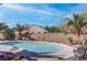 Relaxing backyard pool area with desert plants, mature trees, and a view of the home's exterior at 3640 Chateau Meadow St, Las Vegas, NV 89129