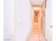 Long hallway with tile floors leading to multiple rooms in the home at 4145 Plumtree St, Las Vegas, NV 89115