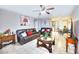 Inviting living room with tile floors, ceiling fan, comfortable seating, and lots of light at 4145 Plumtree St, Las Vegas, NV 89115