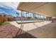 Wide angle shot of a tiled and covered back patio, overlooking a covered pool at 4409 Cinderella Ln, Las Vegas, NV 89102