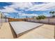 Backyard featuring a covered pool, gravel landscaping, and white fences at 4409 Cinderella Ln, Las Vegas, NV 89102