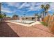 Charming backyard featuring a covered pool, rock landscaping and a wooden fence for added privacy at 4409 Cinderella Ln, Las Vegas, NV 89102