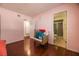 Bright bedroom with wood-look floors, light pink walls, and attached bathroom at 4409 Cinderella Ln, Las Vegas, NV 89102