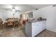 The open dining area features a ceiling fan, unique lighting, and breakfast bar adjacent to the kitchen at 4409 Cinderella Ln, Las Vegas, NV 89102