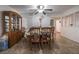 An interior dining area featuring an ornate china cabinet, a ceiling fan, and a view to other rooms at 4409 Cinderella Ln, Las Vegas, NV 89102