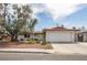 A well-maintained single-story home with a lawn, mature trees, and a classic driveway leading to an attached garage at 4409 Cinderella Ln, Las Vegas, NV 89102