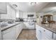 Bright kitchen features white cabinets, granite countertops, and modern appliances for a functional cooking space at 4409 Cinderella Ln, Las Vegas, NV 89102