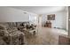 Bright living room featuring tiled floors, a cozy seating area, and access to the outdoor area at 4409 Cinderella Ln, Las Vegas, NV 89102