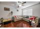 An interior living room area featuring a large sectional, hard wood floors, and lots of natural light at 4409 Cinderella Ln, Las Vegas, NV 89102