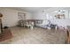 Spacious living room with tiled floors, a brick fireplace, and a large window for natural light at 4409 Cinderella Ln, Las Vegas, NV 89102