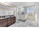 Main bathroom showcasing double sink vanity, walk-in glass shower with marble-look tile at 4822 Jade Ridge St, North Las Vegas, NV 89081