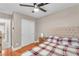 Cozy bedroom featuring a ceiling fan, closet, wood floors, and stylish, comfortable furnishings at 4822 Jade Ridge St, North Las Vegas, NV 89081