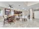 Open-concept dining area featuring tile floors, modern furnishings, and seamless transition to the kitchen and living spaces at 4822 Jade Ridge St, North Las Vegas, NV 89081