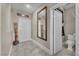 Welcoming foyer with a large mirror, neutral color palette, and access to a half bath at 4822 Jade Ridge St, North Las Vegas, NV 89081