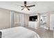 Carpeted main bedroom boasts a ceiling fan, window, and walk-in closet with a view of the bathroom at 4822 Jade Ridge St, North Las Vegas, NV 89081