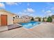 Sparkling in-ground pool with well-maintained landscaping and a sunny patio area at 4822 Jade Ridge St, North Las Vegas, NV 89081