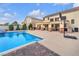 Expansive pool area with an in-ground pool, patio seating, and lush backyard landscaping at 4822 Jade Ridge St, North Las Vegas, NV 89081