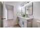 Updated bathroom featuring double sink vanity, modern fixtures, and view into bedroom at 4954 Palmyra Ave, Las Vegas, NV 89146