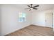 Well-lit bedroom featuring wood floors, a window, and a ceiling fan at 4954 Palmyra Ave, Las Vegas, NV 89146