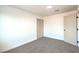 Bedroom with fresh carpet, neutral paint, closet and view of ensuite bathroom at 4954 Palmyra Ave, Las Vegas, NV 89146