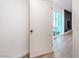 Hallway with light wood floors leading to a sliding glass door and accent wall at 4954 Palmyra Ave, Las Vegas, NV 89146