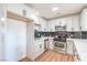 Bright kitchen featuring white cabinets, stainless steel appliances and black subway tile at 4954 Palmyra Ave, Las Vegas, NV 89146