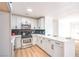 Modern kitchen with stainless steel appliances, white cabinets and black subway tile backsplash at 4954 Palmyra Ave, Las Vegas, NV 89146