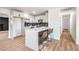 Beautiful kitchen with white cabinets, sleek countertops, stainless steel appliances and bar seating at 4954 Palmyra Ave, Las Vegas, NV 89146