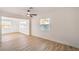 Light-filled living area with wood floors and large windows, seamlessly connected to other rooms at 4954 Palmyra Ave, Las Vegas, NV 89146